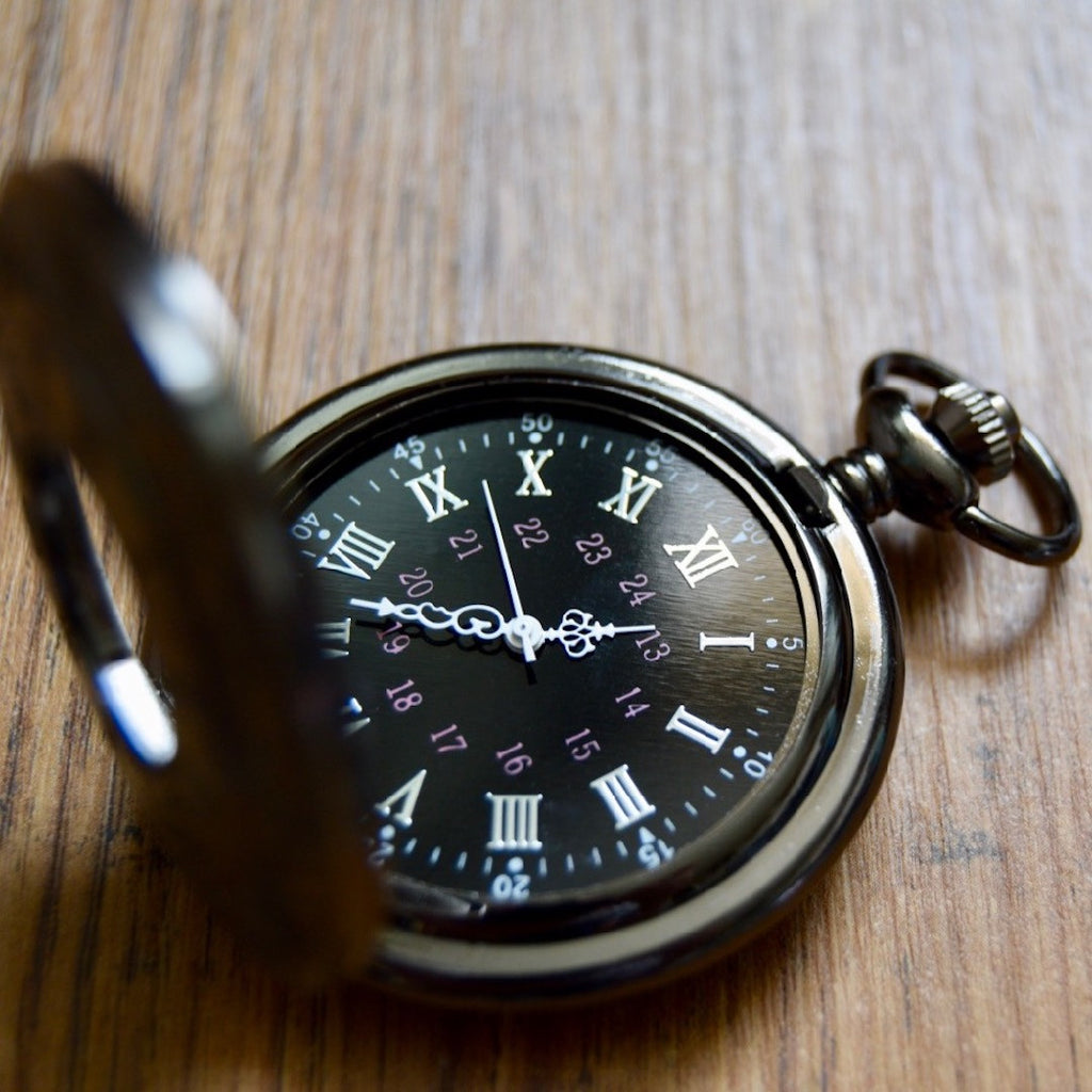 Gunmetal pocket watch open wood